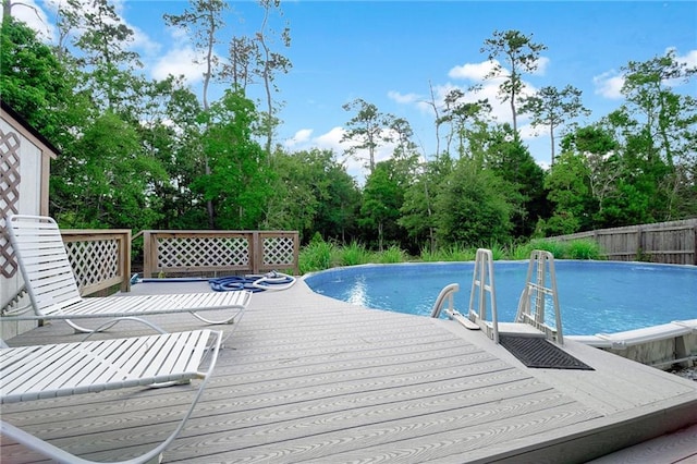 2004 Dierdorff Ct, Slidell, LA 70461 - swimming pool featuring a wooden deck and view of wooded area