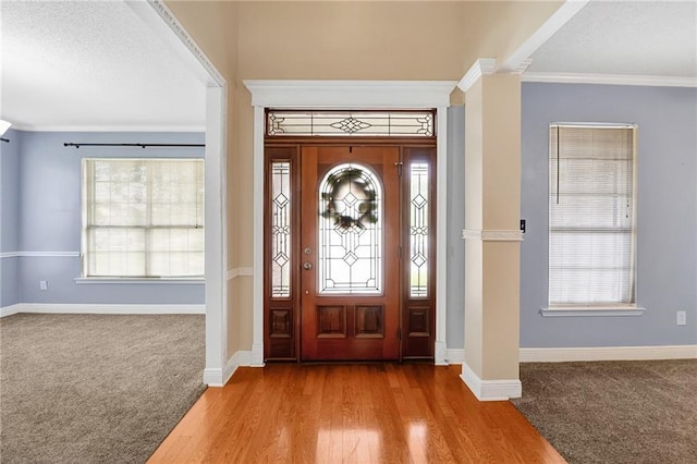 2004 Dierdorff Ct, Slidell, LA 70461 - carpeted foyer entrance featuring decorative columns, crown molding, and wood finished floors