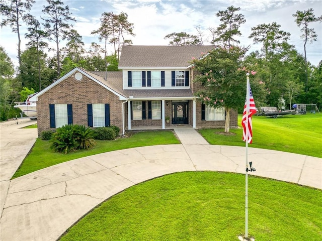 2004 Dierdorff Ct, Slidell, LA 70461 - traditional-style home with curved driveway, brick siding, a front lawn, and a shingled roof