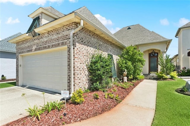 1410 Royal Palm Dr, Slidell, LA 70458 - view of front of property with brick siding, roof with shingles, driveway, a garage, and a front yard
