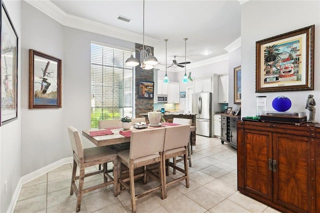 1410 Royal Palm Dr, Slidell, LA 70458 - dining room featuring light tile patterned floors, ornamental molding, and a chandelier