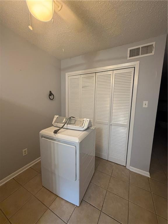 3112 Phoenix St Unit D, Kenner, LA 70065 - washroom featuring washer / dryer, light tile patterned flooring, and a textured ceiling