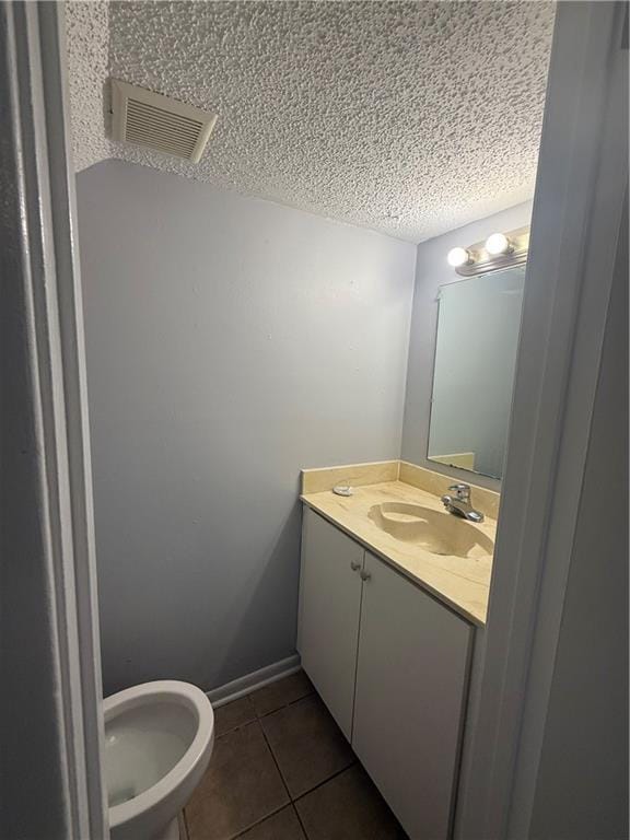 3112 Phoenix St Unit D, Kenner, LA 70065 - bathroom featuring tile patterned floors, vanity, and a textured ceiling