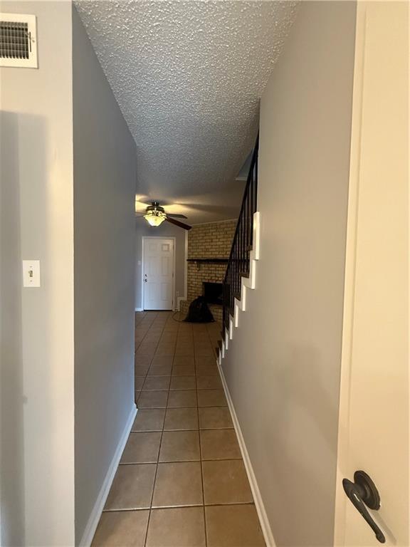 3112 Phoenix St Unit D, Kenner, LA 70065 - corridor with tile patterned floors and a textured ceiling