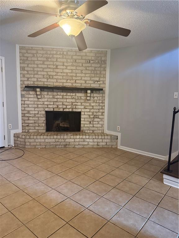 3112 Phoenix St Unit D, Kenner, LA 70065 - unfurnished living room featuring a textured ceiling, light tile patterned floors, a ceiling fan, and a brick fireplace