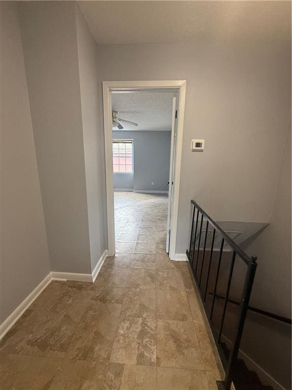 3112 Phoenix St Unit D, Kenner, LA 70065 - hallway featuring a textured ceiling, an upstairs landing, and stone finish floors