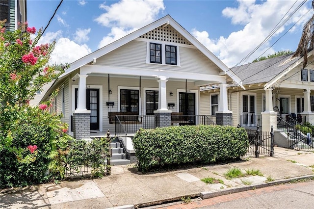 2231 Constance St, New Orleans, LA 70130 - view of front of property featuring covered porch and brick siding