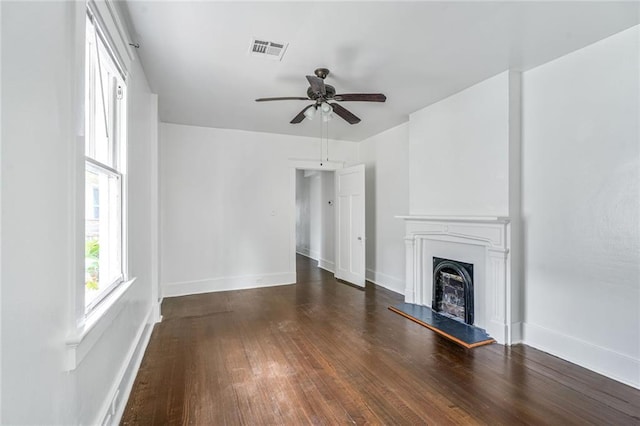 2231 Constance St, New Orleans, LA 70130 - unfurnished living room featuring ceiling fan, hardwood / wood-style flooring, and a fireplace with raised hearth