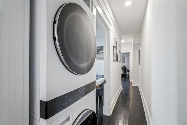 2231 Constance St, New Orleans, LA 70130 - washroom with stacked washer / dryer, dark wood-type flooring, and recessed lighting