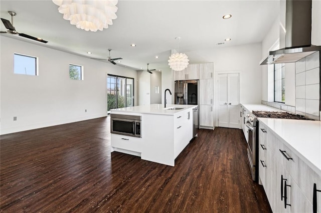 6000 Franklin Ave, New Orleans, LA 70122 - kitchen featuring appliances with stainless steel finishes, a ceiling fan, wall chimney exhaust hood, open floor plan, and recessed lighting