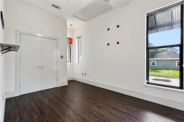 6000 Franklin Ave, New Orleans, LA 70122 - unfurnished bedroom with attic access, dark wood finished floors, and a closet