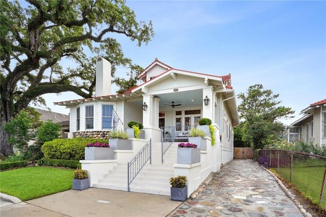 1455 Moss St, New Orleans, LA 70119 - view of front of house with a porch, ceiling fan, and a chimney