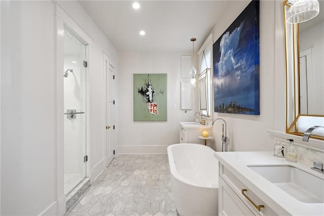 1455 Moss St, New Orleans, LA 70119 - full bathroom featuring two vanities, a soaking tub, recessed lighting, a stall shower, and tile patterned floors