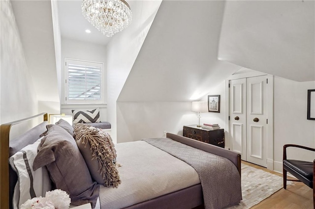 1455 Moss St, New Orleans, LA 70119 - bedroom with wood finished floors, a chandelier, vaulted ceiling, a closet, and recessed lighting