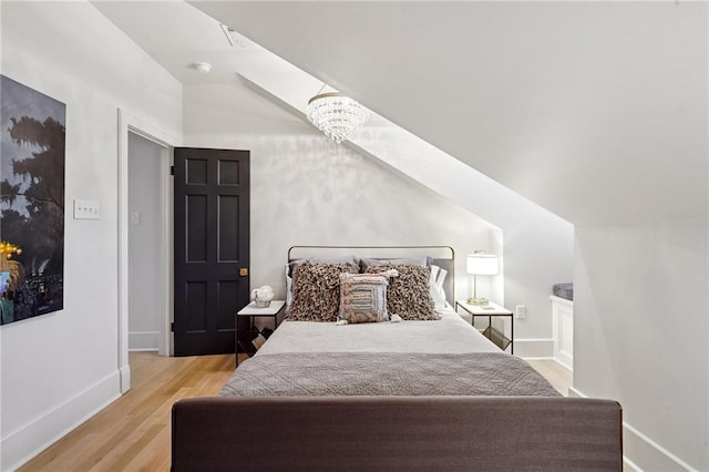 1455 Moss St, New Orleans, LA 70119 - bedroom featuring vaulted ceiling and wood finished floors