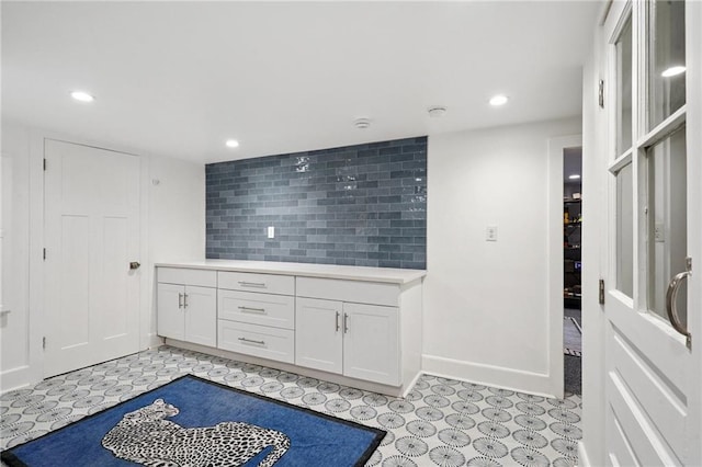 1455 Moss St, New Orleans, LA 70119 - kitchen with white cabinets, recessed lighting, light countertops, and tasteful backsplash