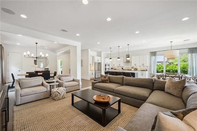 800 Ridgelake Dr, Metairie, LA 70001 - living area featuring a chandelier, recessed lighting, and light wood-style floors