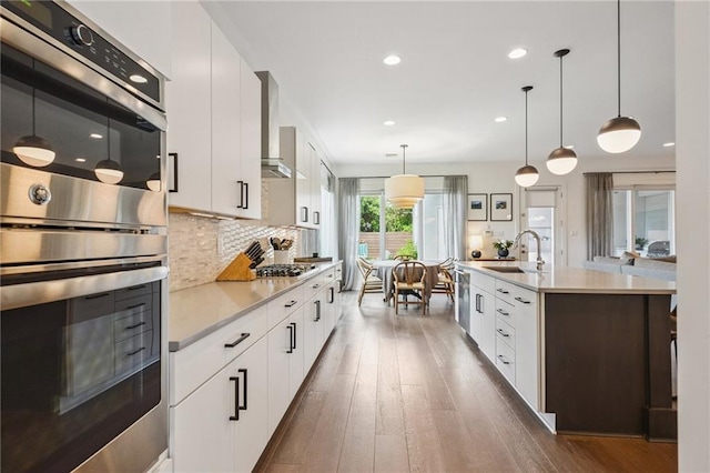 800 Ridgelake Dr, Metairie, LA 70001 - kitchen featuring stainless steel appliances, light countertops, dark wood-style floors, modern cabinets, and tasteful backsplash
