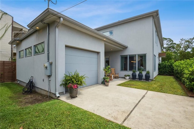 800 Ridgelake Dr, Metairie, LA 70001 - back of property featuring an attached garage, concrete driveway, and stucco siding