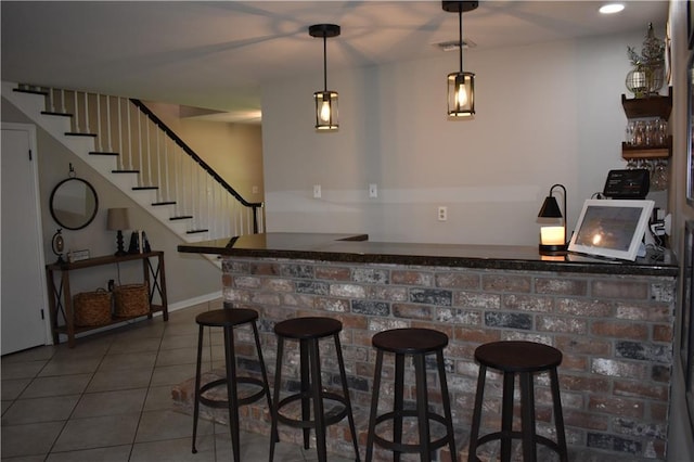 14 Platt St, Kenner, LA 70065 - indoor dry bar featuring stairs, tile patterned floors, and decorative light fixtures