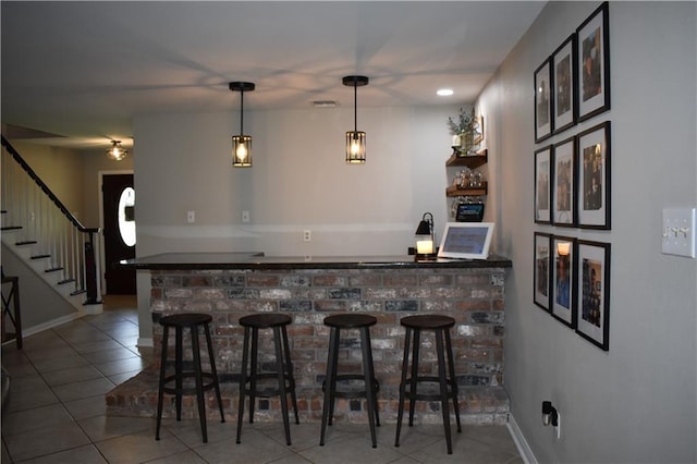 14 Platt St, Kenner, LA 70065 - indoor bar with tile patterned floors, stairs, and pendant lighting