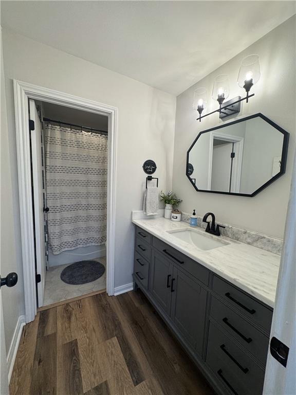 14 Platt St, Kenner, LA 70065 - full bathroom with vanity, wood finished floors, and a chandelier
