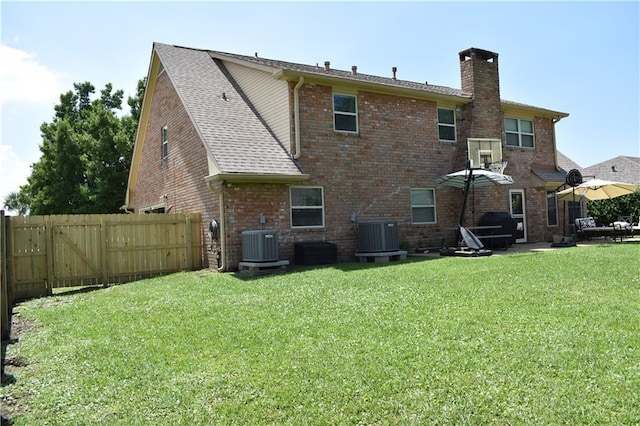 14 Platt St, Kenner, LA 70065 - rear view of house featuring a chimney, a patio area, brick siding, a gate, and roof with shingles