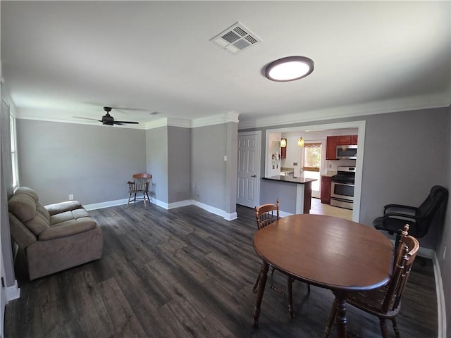 557 Grove Ave, Harahan, LA 70123 - dining space featuring a ceiling fan, dark wood-style floors, and crown molding