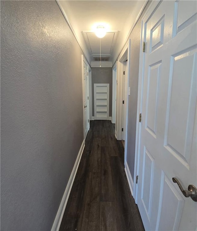557 Grove Ave, Harahan, LA 70123 - corridor with attic access, dark wood-style flooring, and a textured wall