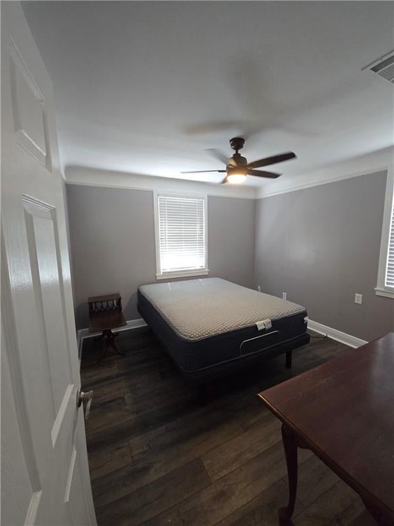 557 Grove Ave, Harahan, LA 70123 - bedroom with dark wood-type flooring and ceiling fan
