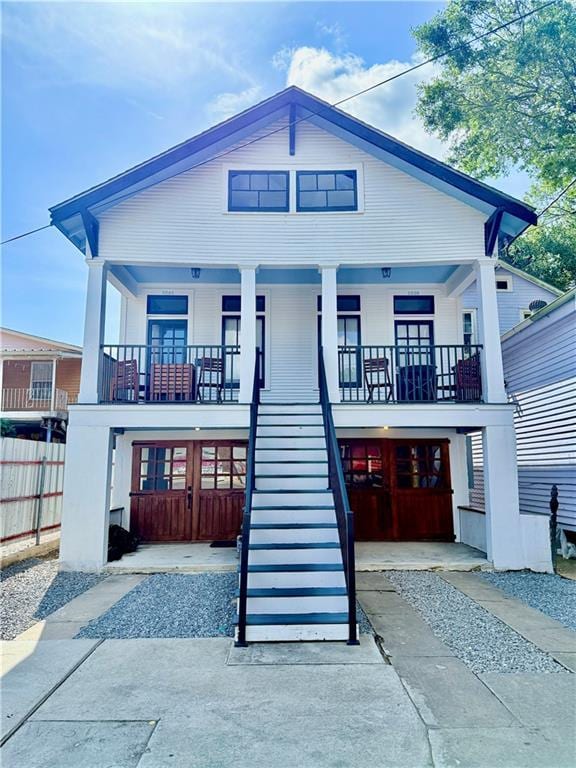 1039-41 Poland Ave, New Orleans, LA 70117 - view of front of home featuring stairs, covered porch, and driveway