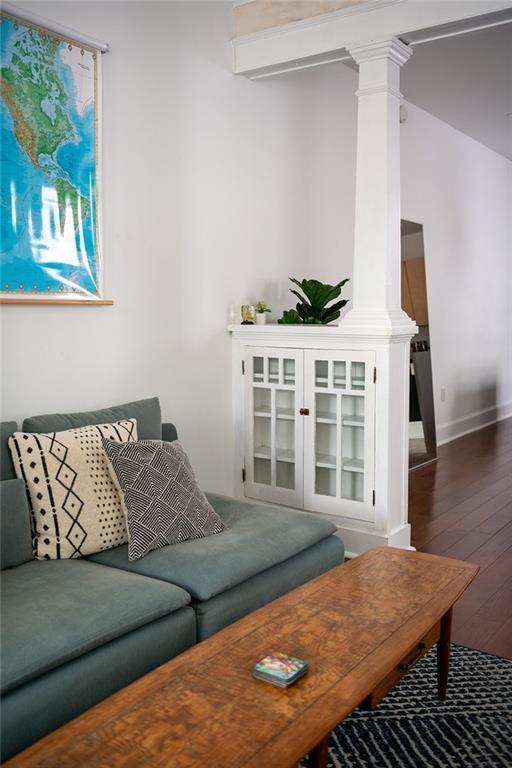 1039-41 Poland Ave, New Orleans, LA 70117 - living room featuring ornate columns and hardwood / wood-style flooring