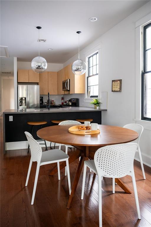 1039-41 Poland Ave, New Orleans, LA 70117 - dining room with wood finished floors and healthy amount of natural light