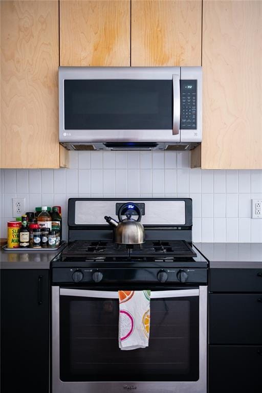 1039-41 Poland Ave, New Orleans, LA 70117 - kitchen featuring stainless steel appliances, tasteful backsplash, and light countertops