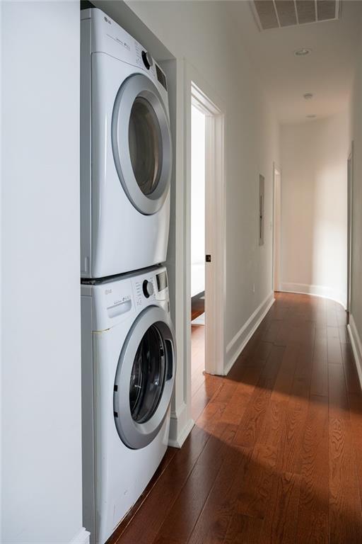 1039-41 Poland Ave, New Orleans, LA 70117 - washroom with stacked washer / dryer and wood-type flooring