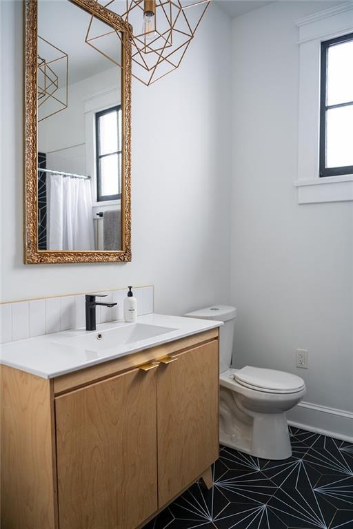1039-41 Poland Ave, New Orleans, LA 70117 - full bathroom with vanity, healthy amount of natural light, and tile patterned floors