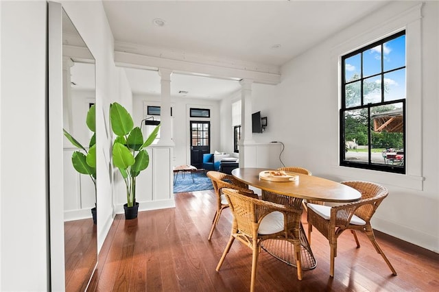 1039-41 Poland Ave, New Orleans, LA 70117 - dining area featuring ornate columns, plenty of natural light, and hardwood / wood-style flooring