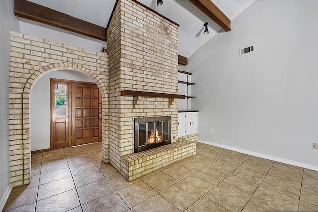905 Rue Rochelle, Slidell, LA 70458 - unfurnished living room with beamed ceiling, tile patterned floors, arched walkways, a fireplace, and high vaulted ceiling