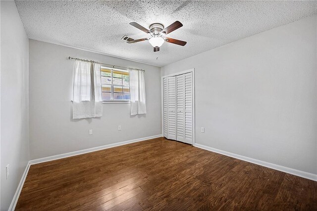 905 Rue Rochelle, Slidell, LA 70458 - unfurnished bedroom with a closet, wood finished floors, a textured ceiling, and ceiling fan