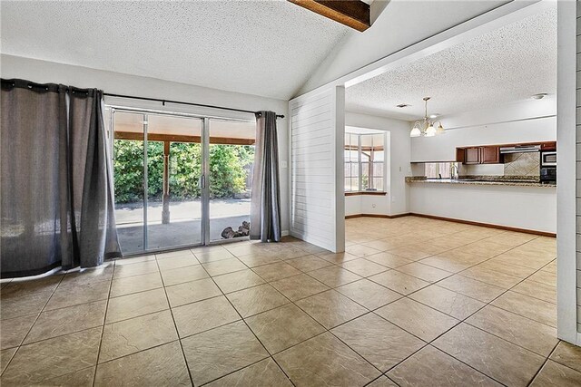 905 Rue Rochelle, Slidell, LA 70458 - spare room with a textured ceiling, light tile patterned floors, and a chandelier