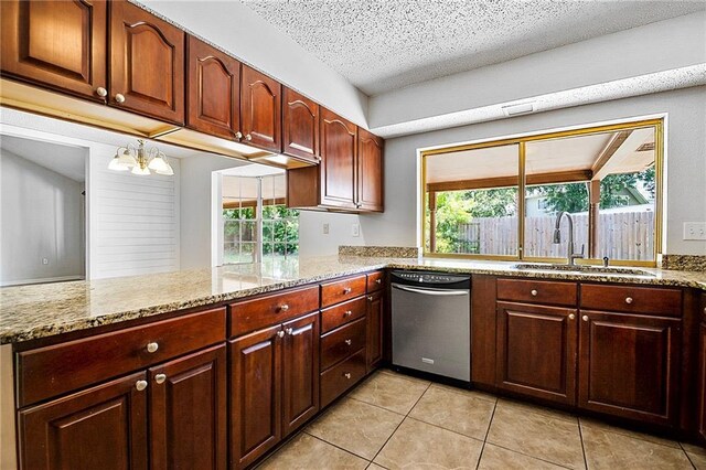 905 Rue Rochelle, Slidell, LA 70458 - kitchen with stainless steel dishwasher, light stone countertops, light tile patterned floors, a chandelier, and a textured ceiling