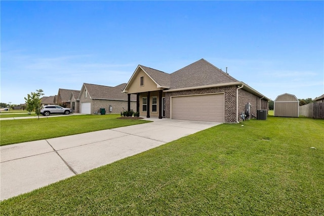 42016 Wood Ave, Ponchatoula, LA 70454 - view of front of house with an attached garage, a front yard, brick siding, driveway, and a storage shed