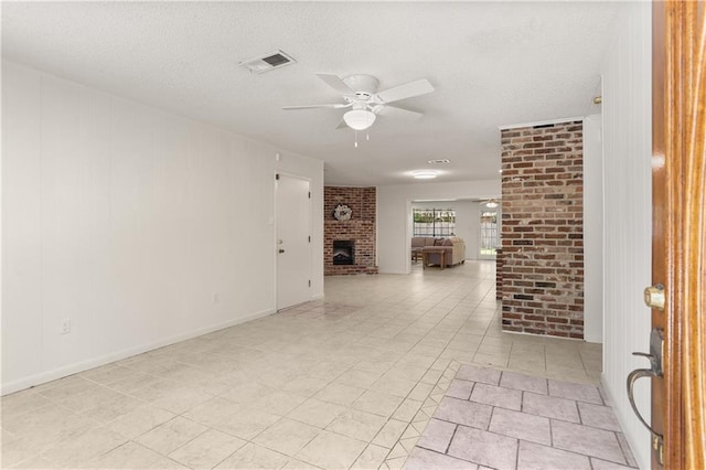 4720 Sheridan Ave, Metairie, LA 70002 - unfurnished living room featuring a ceiling fan, a fireplace, and a textured ceiling