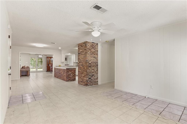 4720 Sheridan Ave, Metairie, LA 70002 - unfurnished living room featuring a ceiling fan and a textured ceiling