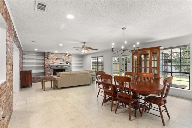 4720 Sheridan Ave, Metairie, LA 70002 - dining room with a textured ceiling, plenty of natural light, a brick fireplace, ceiling fan, and recessed lighting