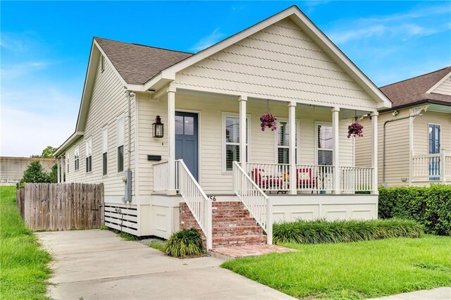 5756 Warrington Dr, New Orleans, LA 70122 - view of front of property featuring a porch and a shingled roof