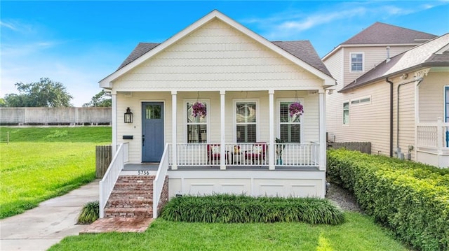5756 Warrington Dr, New Orleans, LA 70122 - view of front of house with a porch, a front yard, and stairs