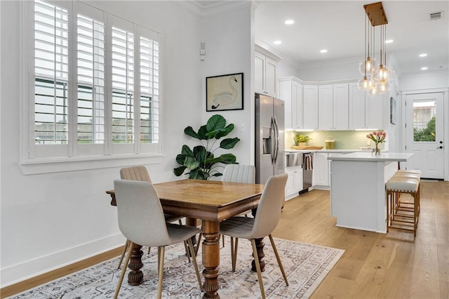 5756 Warrington Dr, New Orleans, LA 70122 - dining space with ornamental molding, light wood-style flooring, and recessed lighting