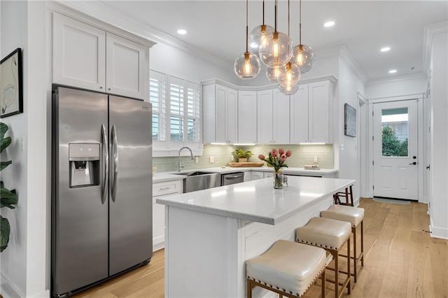 5756 Warrington Dr, New Orleans, LA 70122 - kitchen with stainless steel appliances, plenty of natural light, crown molding, a breakfast bar area, and tasteful backsplash