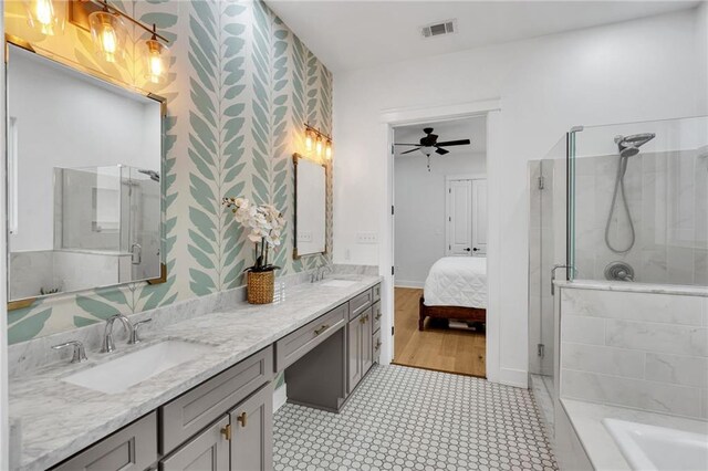 5756 Warrington Dr, New Orleans, LA 70122 - ensuite bathroom featuring a stall shower, wallpapered walls, double vanity, a ceiling fan, and a tub